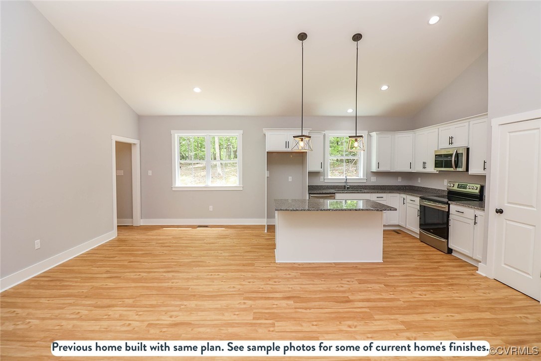 1676 Patterson Road Buckingham, VA 23921 - Photo 17 of 24 a view of a kitchen with kitchen island a sink stainless steel appliances and window