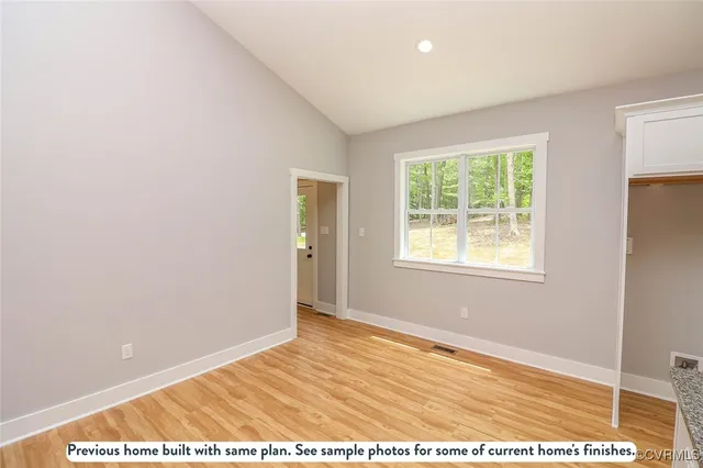 a view of a kitchen with kitchen island a sink stainless steel appliances and window