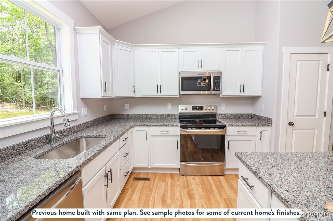 1676 Patterson Road Buckingham, VA 23921 - Photo 19 of 24 a kitchen with granite countertop a stove a sink and a microwave