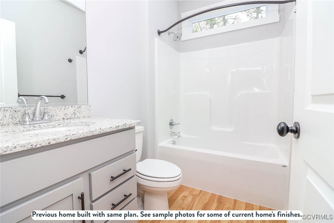 1676 Patterson Road Buckingham, VA 23921 - Photo 5 of 24 a bathroom with a granite countertop sink toilet a shower and a mirror