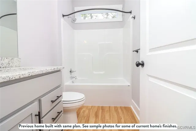 a bathroom with a granite countertop sink toilet a shower and a mirror