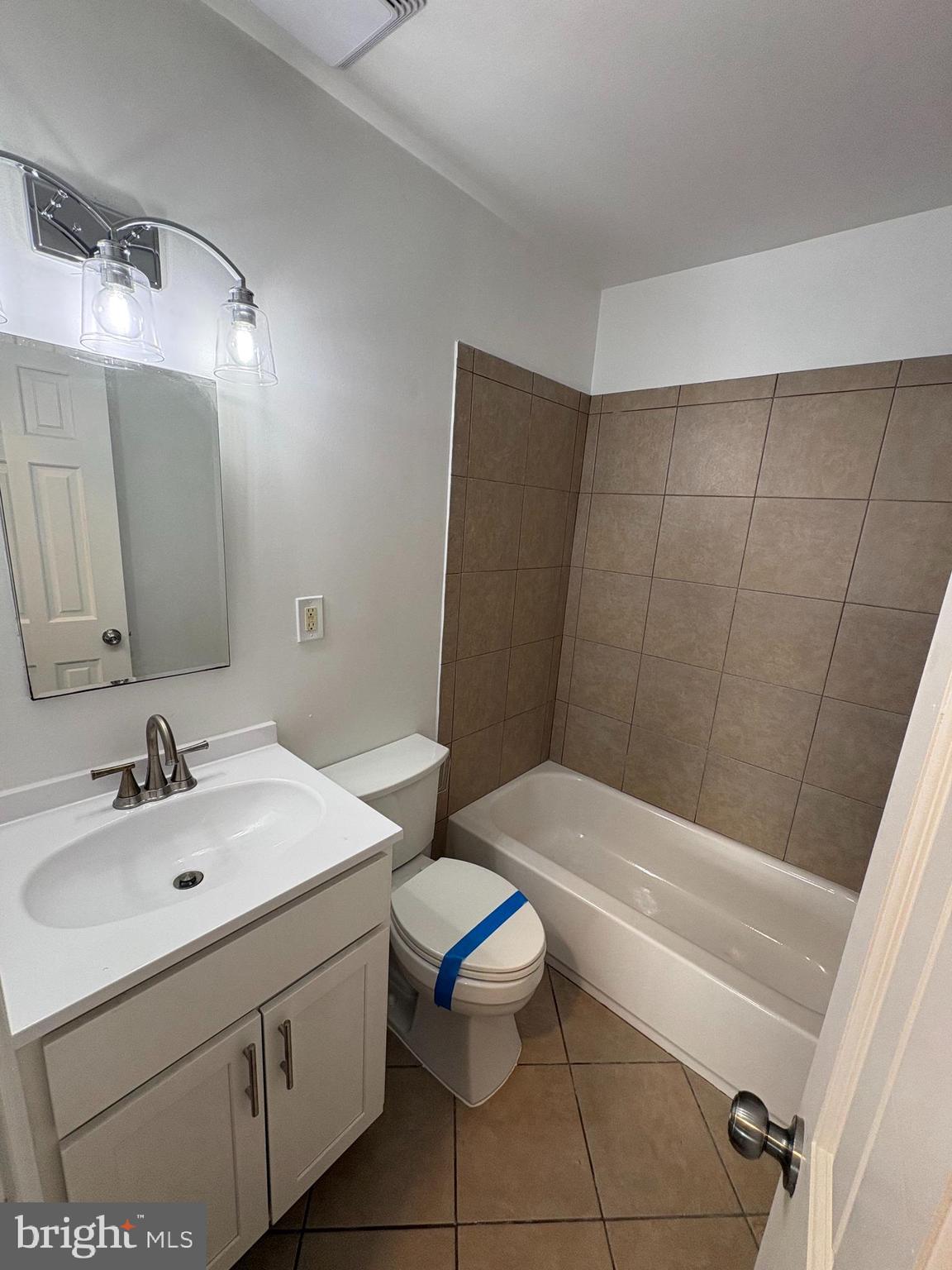 1206 16th Street Northeast Washington, DC 20002 - Photo 10 of 15 a bathroom with a sink a toilet and a mirror