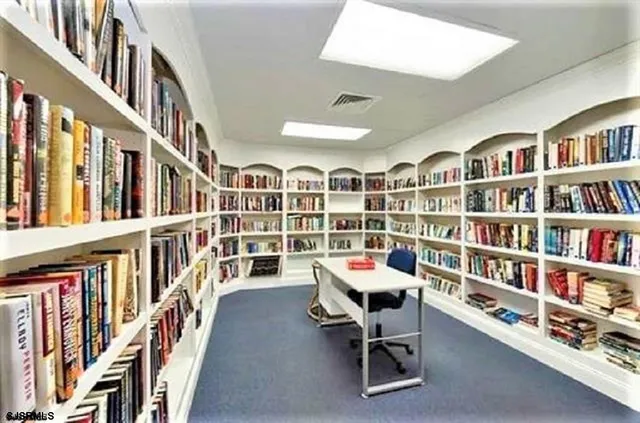 a reading room with lots of furniture and book shelf