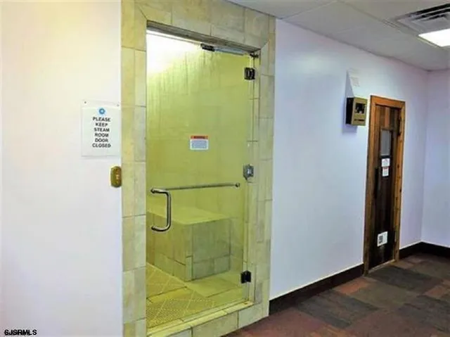 a bathroom with a shower and a mirror