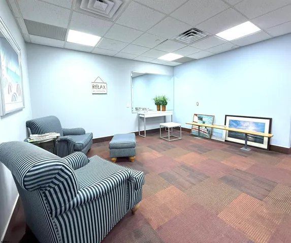 a bedroom with two beds and a desk