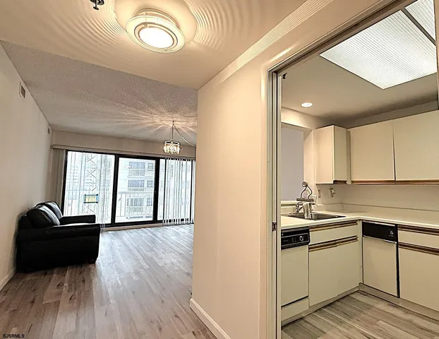 a view of a kitchen with a sink wooden floor and windows
