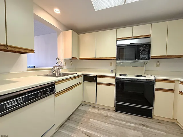 a kitchen with a sink stove and microwave