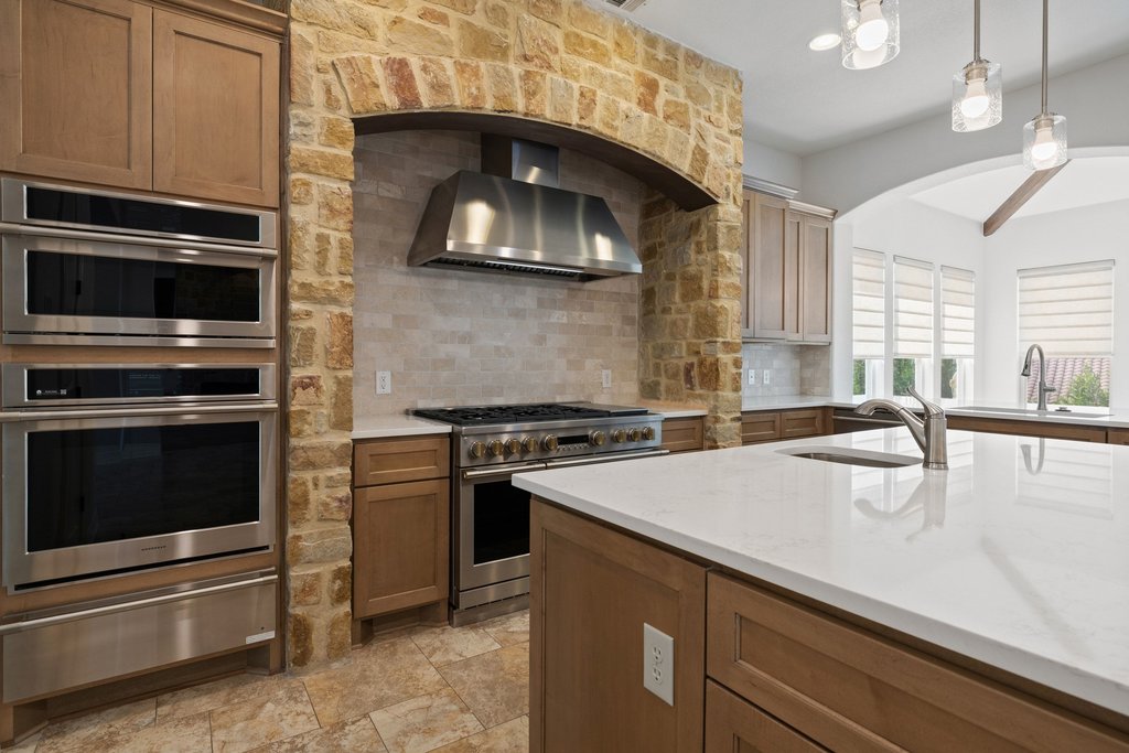 109 Largo Cove Austin, TX 78734 - Photo 9 of 40 A well-lit kitchen features modern stainless steel appliances and abundant counter space.