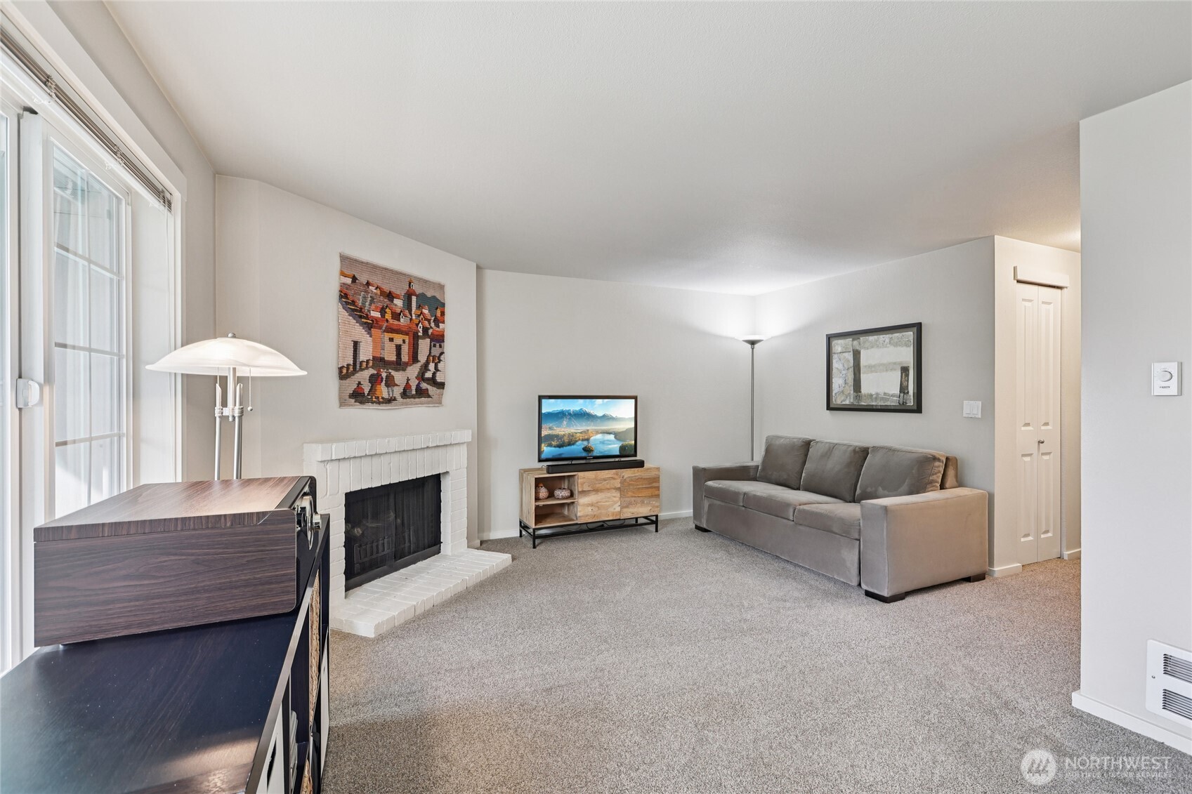 12404 East Gibson Road, Unit N203 Everett, WA 98204 - Photo 3 of 28 a living room with furniture and a fireplace