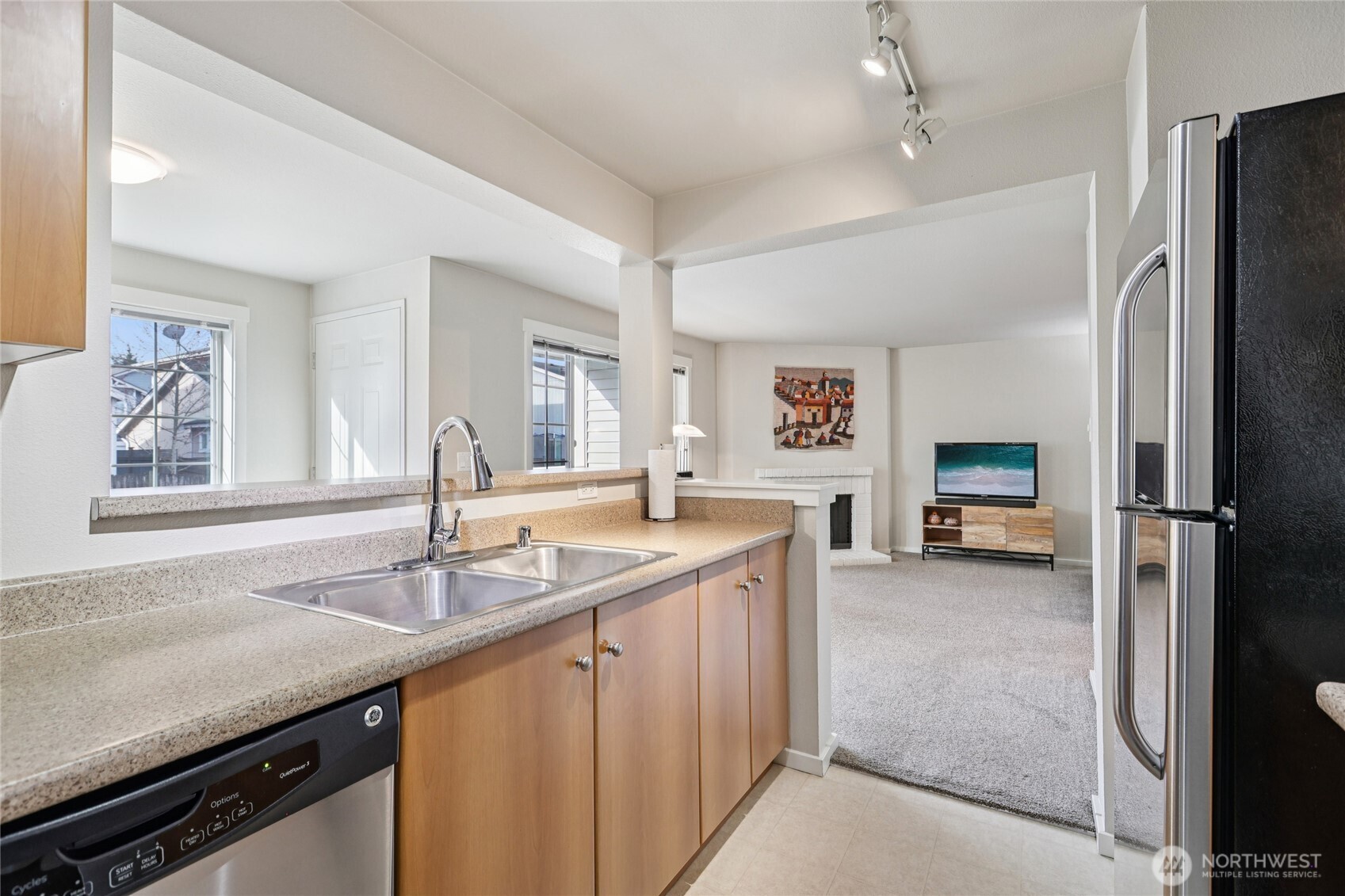 12404 East Gibson Road, Unit N203 Everett, WA 98204 - Photo 8 of 28 a kitchen with a sink and a refrigerator