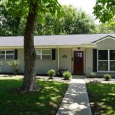 a front view of a house with a yard and porch