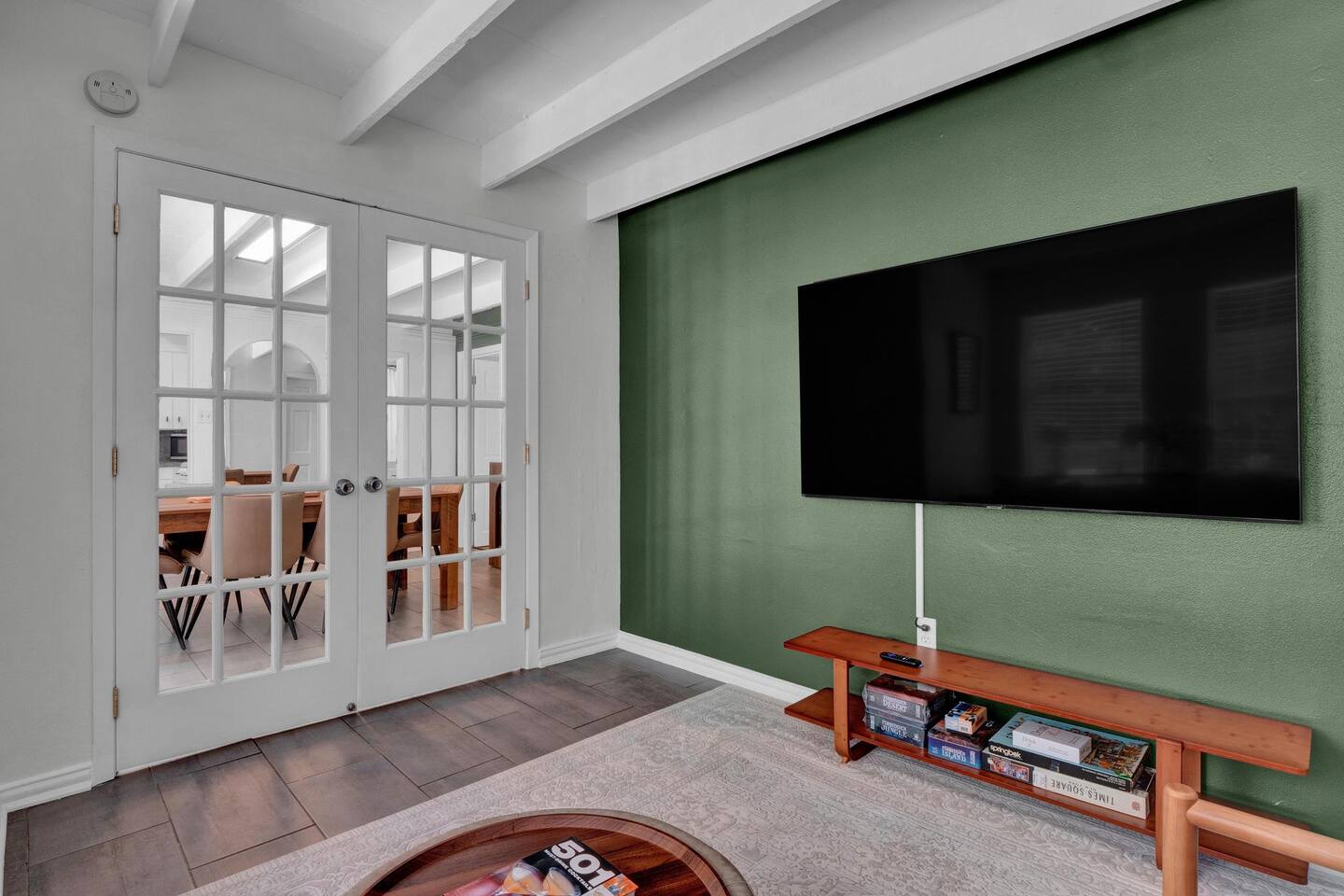 211 Lessin Lane, Unit B Austin, TX 78704 - Photo 6 of 18 Living room with french doors, wood finished floors, and beamed ceiling