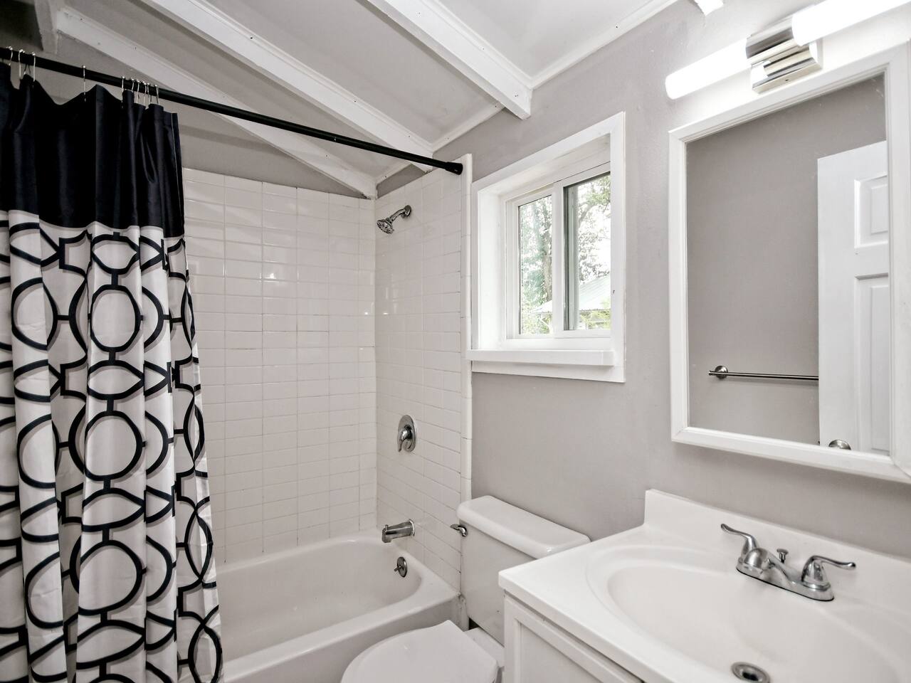 211 Lessin Lane, Unit B Austin, TX 78704 - Photo 8 of 18 Bathroom with shower / bath combo with shower curtain, vanity, and vaulted ceiling with beams