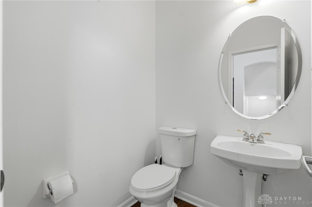 70 Martin Lane Springboro, OH 45066 - Photo 24 of 69 This clean and bright powder room features a classic pedestal sink and toilet.