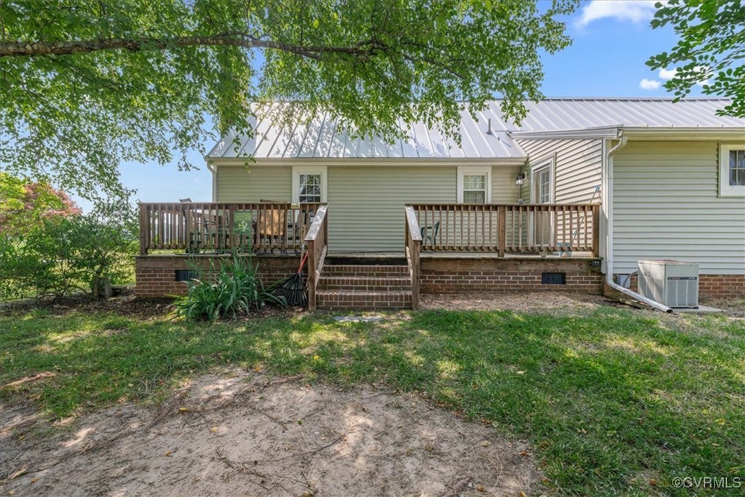 35161 Owens Grove Road Waverly, VA 23890 - Photo 26 of 35 Back of property with a deck, metal roof, a lawn,