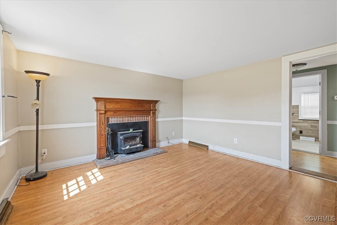 35161 Owens Grove Road Waverly, VA 23890 - Photo 6 of 35 Unfurnished living room featuring a wood stove, wo
