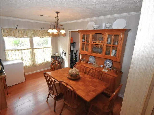 a backyard of a house with a yard and covered outdoor seating