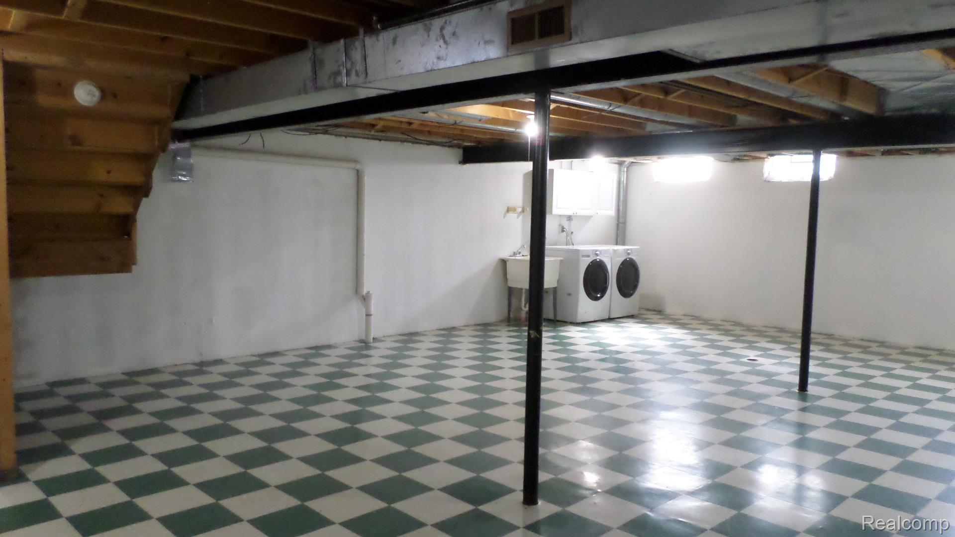 33831 Hooker Road, Unit 6 New Baltimore, MI 48047 - Photo 25 of 34 Below grade area with tile patterned floors and washing machine and clothes dryer
