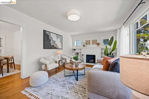 a living room with furniture a rug and a large window