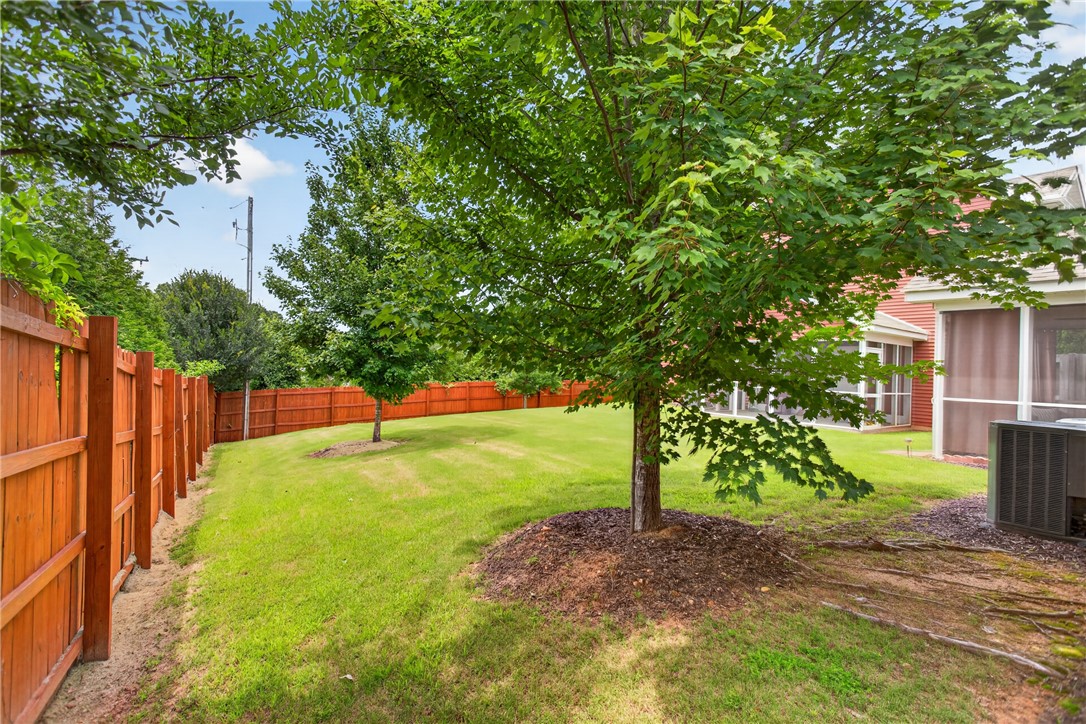 235 Pendleton Road, Unit K1 Clemson, SC 29631 - Photo 7 of 49 A verdant lawn bordered by a tall wooden fence creates a private outdoor sanctuary.
