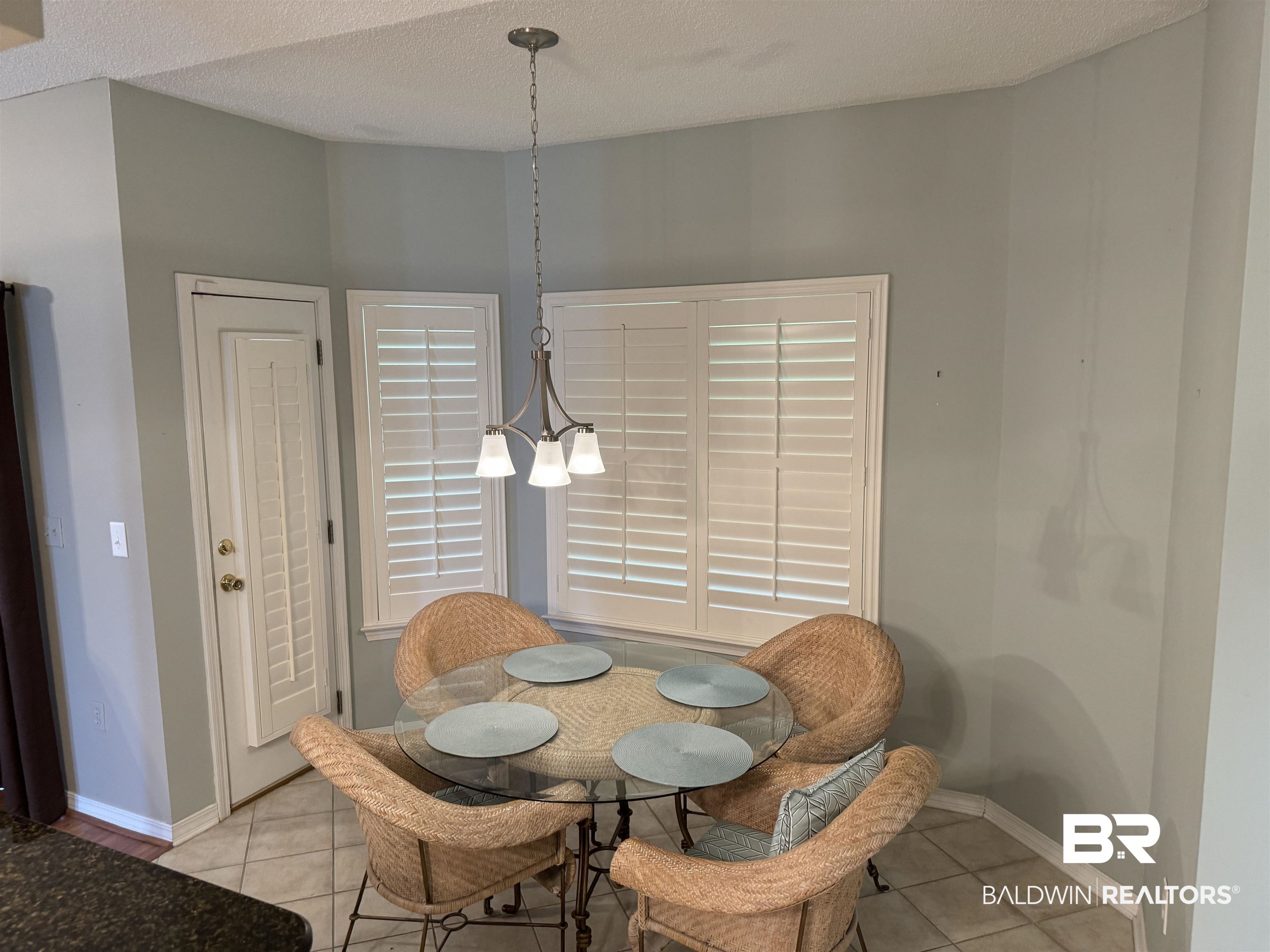 9139 Clubhouse Drive Foley, AL 36535 - Photo 18 of 30 Tiled dining area featuring a notable chandelier and a textured ceiling