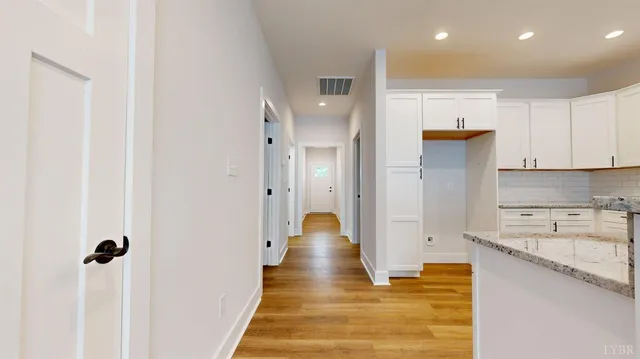 a view of a kitchen with white cabinets and a sink