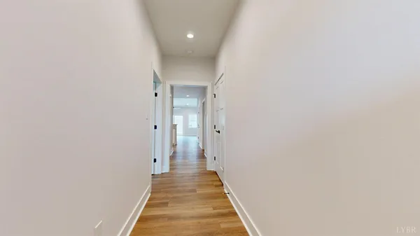 a view of a hallway with wooden floor