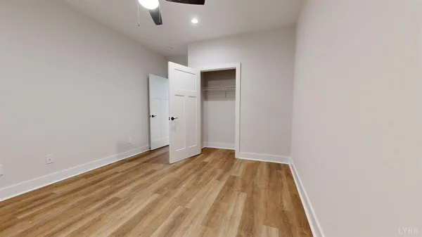 a view of an empty room with bathroom