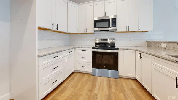 a kitchen with stainless steel appliances granite countertop a stove and a sink