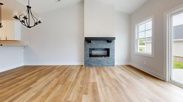 a view of empty room with windows and fireplace