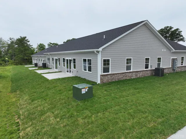 a view of a house with a backyard and a patio