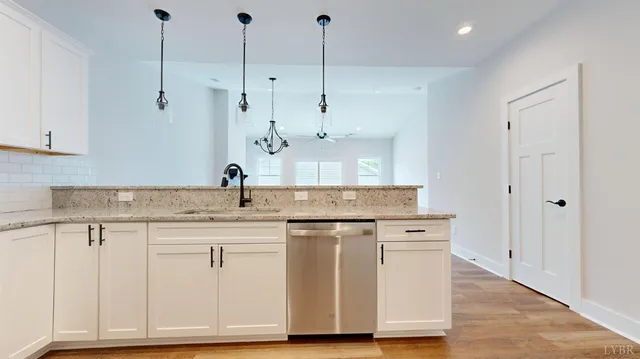 a kitchen with a sink cabinets and wooden floor