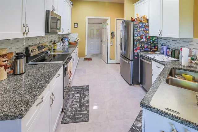 a kitchen with sink stove and refrigerator