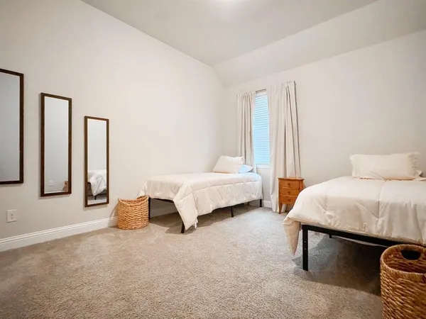 a spacious bedroom with a bed and window