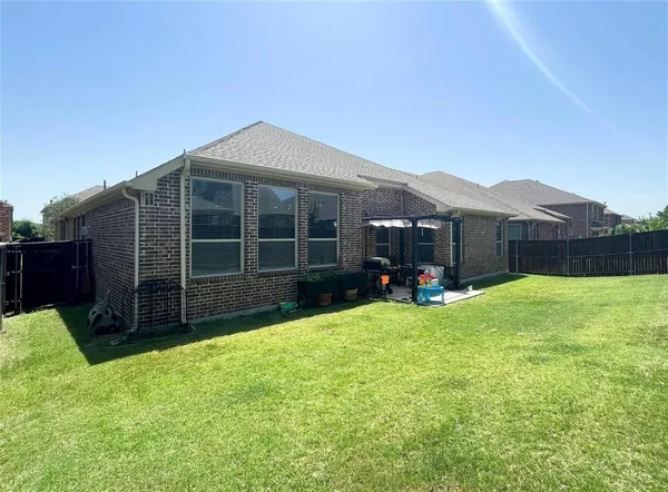 a view of a house with a yard and porch