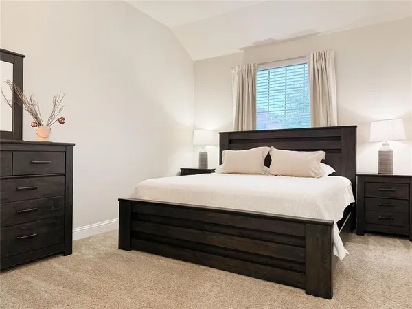 a bedroom with a bed and window