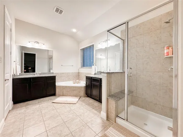 a large bathroom with a glass door shower a sink and a bathtub