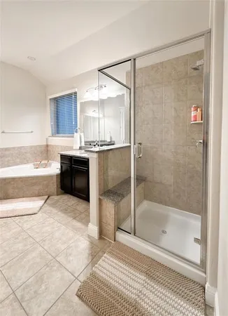 a bathroom with a bathtub and a shower