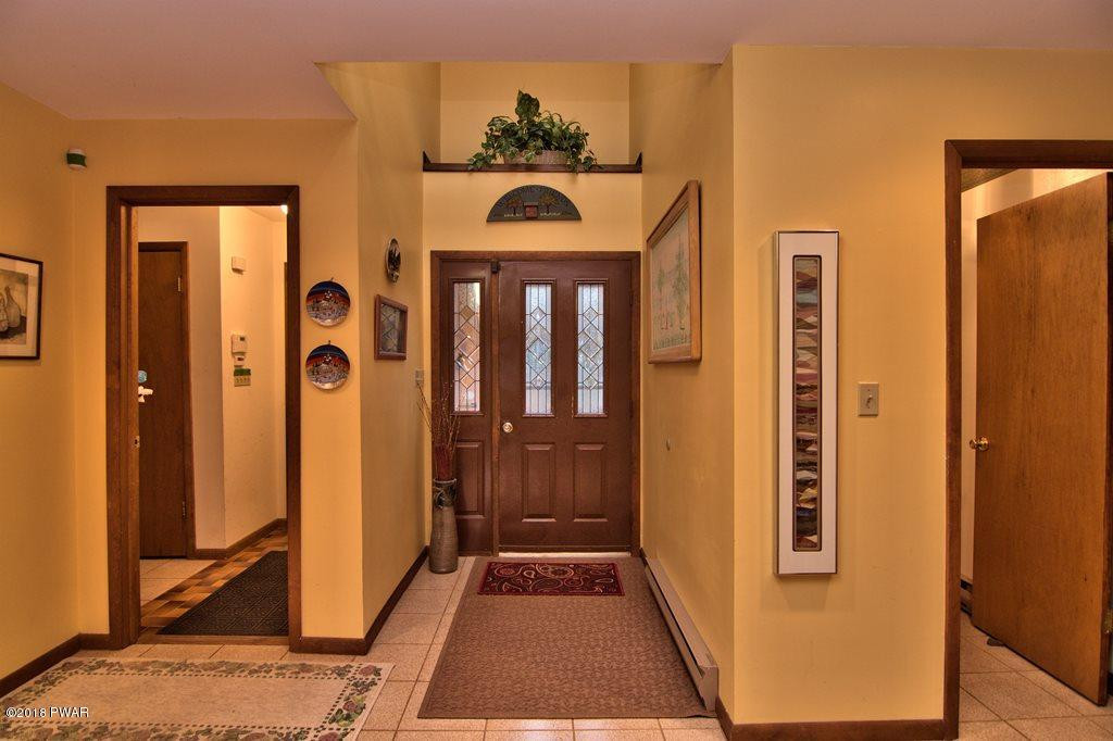 3042 Northgate Road Lake Ariel, PA 18436 - Photo 4 of 37 a view of a hallway with wooden floor and a living room