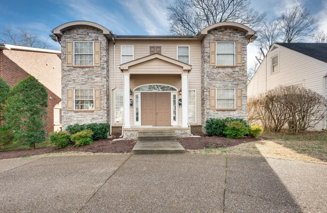 a front view of a house with a garden
