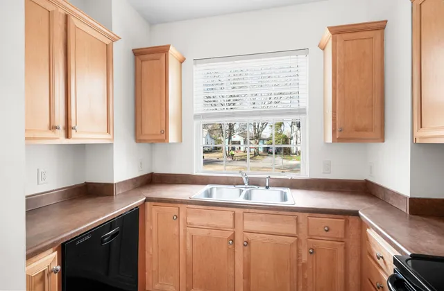a kitchen with wooden cabinets and a stove top oven
