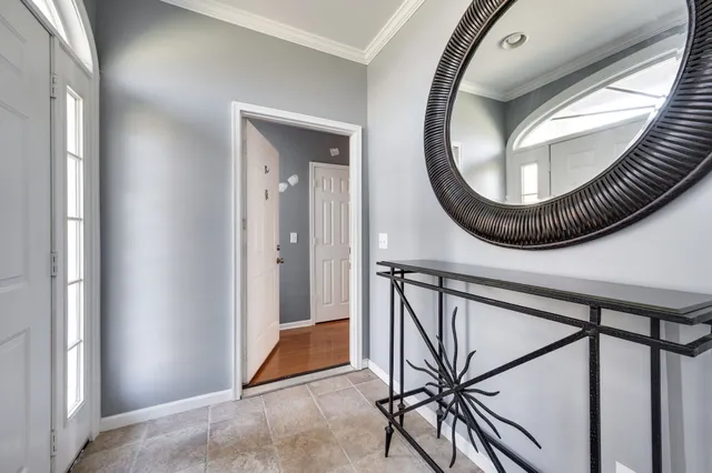 a view of an entryway with wooden floor and mirror