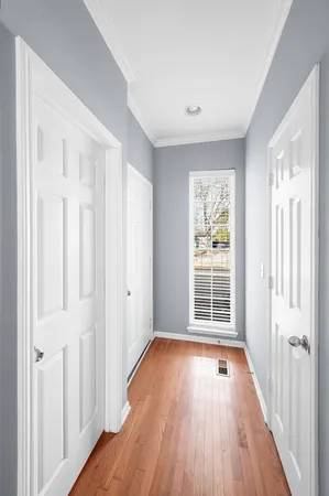 a view of a room with wooden floor and windows