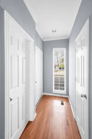 a view of a room with wooden floor and windows