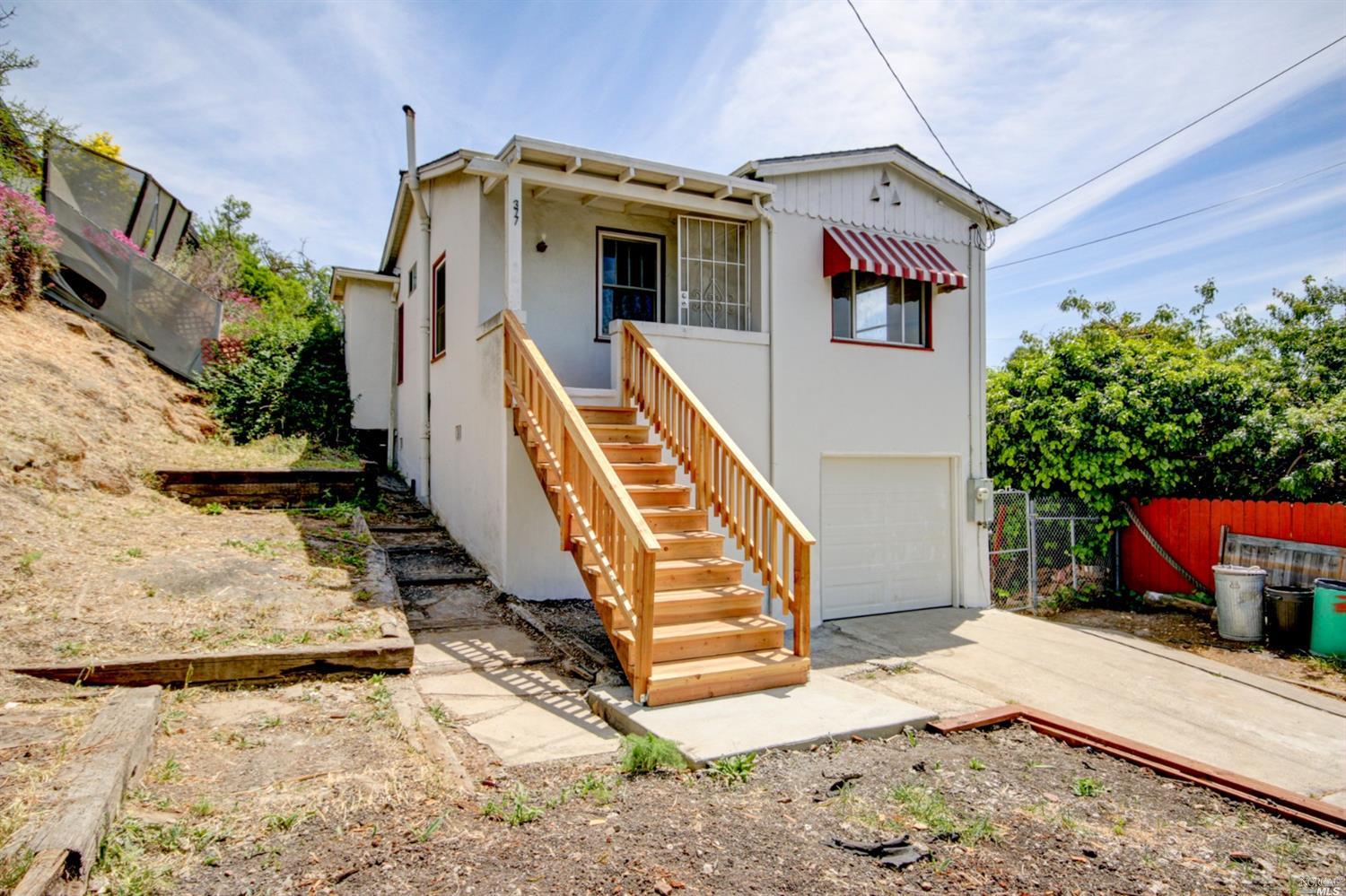 377 Vaqueros Avenue Rodeo, CA 94572 - Photo 1 of 1 a front view of a house with a yard