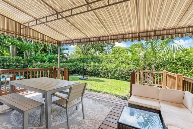 a view of a patio with a table chairs and backyard