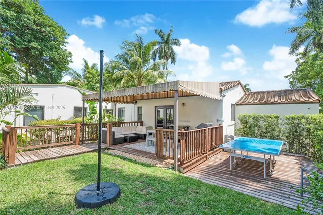 a view of a house with backyard and a patio