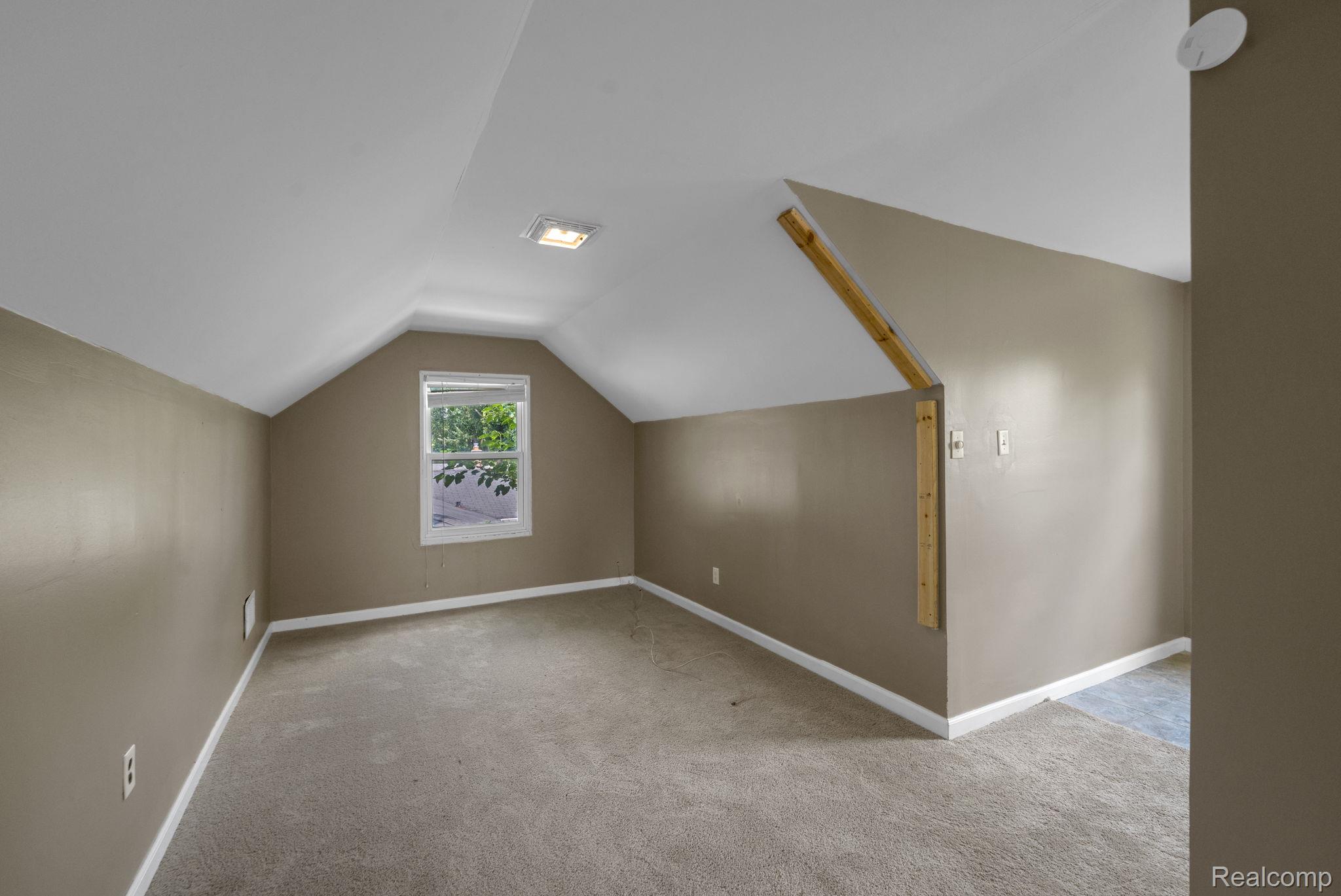 7641 Pelham Road Allen Park, MI 48101 - Photo 16 of 21 Carpeted room featuring a white-framed window, sloped ceilings, recessed lighting, and taupe walls