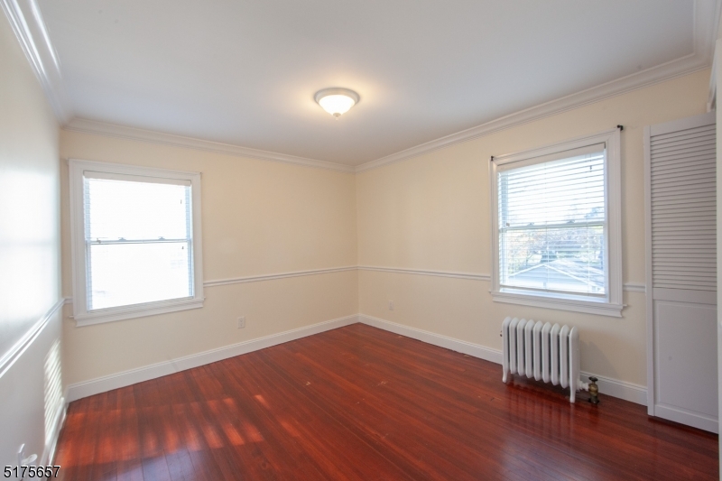 16 Columbus Avenue Glen Ridge, NJ 07028 - Photo 8 of 14 an empty room with wooden floor and windows