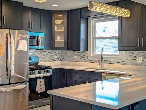 a kitchen with stainless steel appliances a sink stove and cabinets